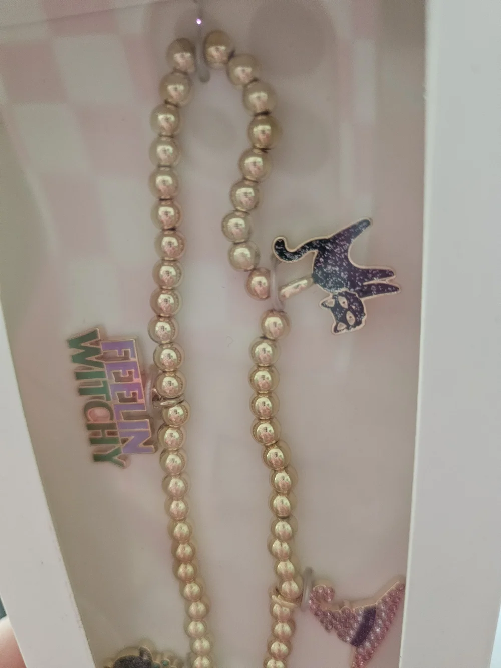 BaubleBar Gold Beaded Phone Charm Wristlet with Enamel Accents